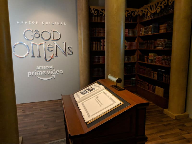 Book is on display with the Amazon Studios Good Omens logo behind it